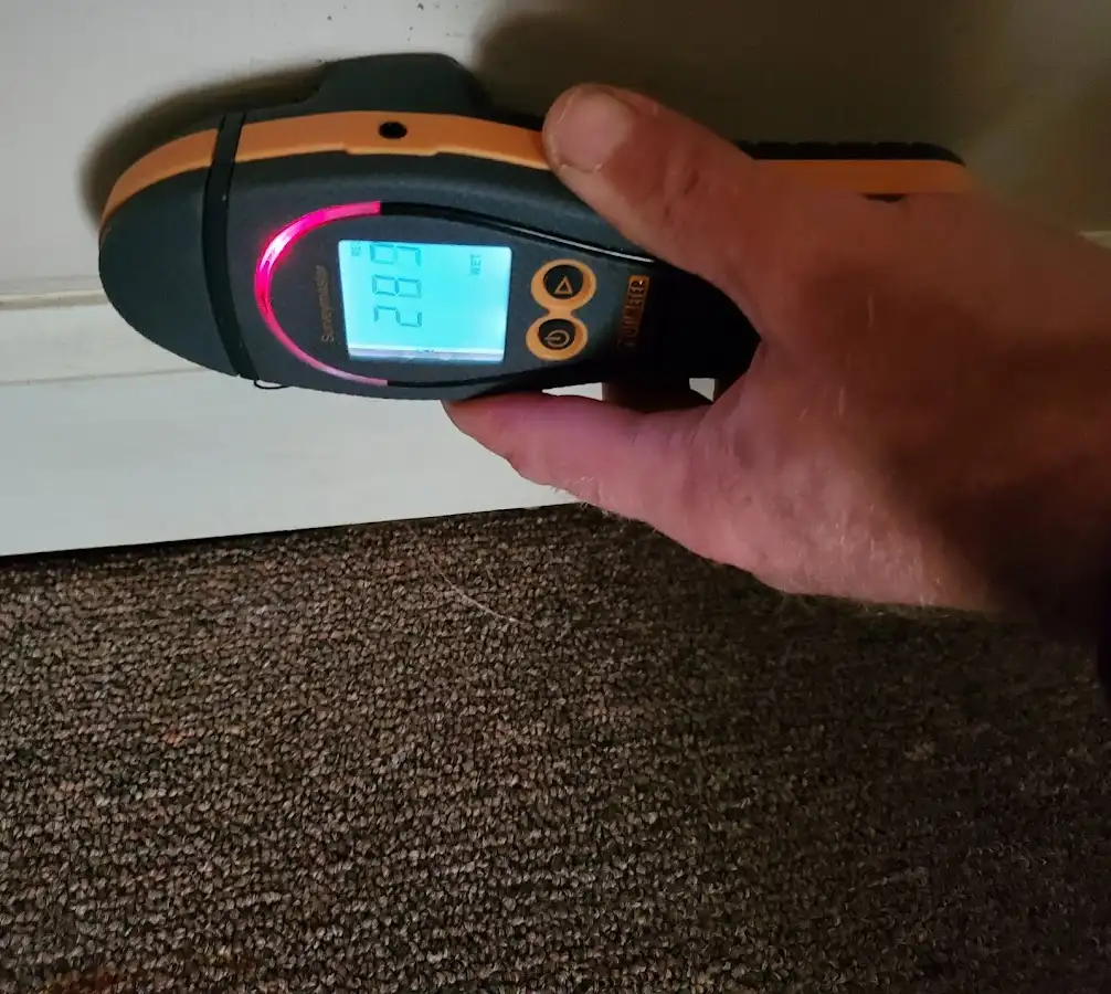 Moisture detection at baseboard during Storm Damage Restoration in Maynard